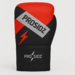 Heavy bag boxing gloves PRO SIDZ red black showing reinforced wrist strap closure with PRO SIDZ logo lightning bolt detail and premium padding for punching bag training protection