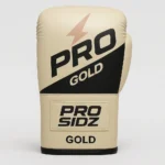 PRO SIDZ Gold Boxing Gloves front and back view showing black logo, lightning bolt design, hook and loop closure on cream colored premium synthetic leather