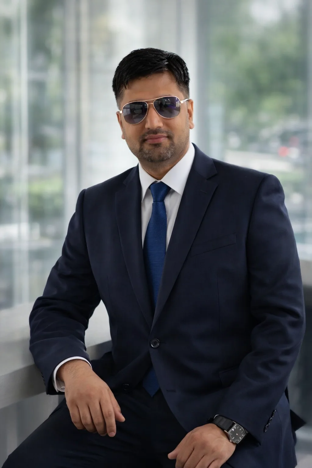 Founder of Prosidz Boxing Company (prosidz.com) in a professional business suit, representing leadership in boxing and combat sports equipment manufacturing.