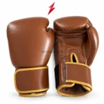 Brown-and-gold boxing glove pair with rounded knuckle panels, light palm stitching, and PSI logo above; PROSIDZ Industries, Wholesale Boxing Gloves suppliers.