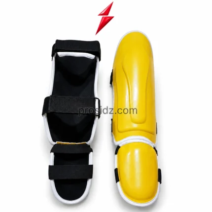 PSI yellow black MMA shin guards front view with molded protection shell